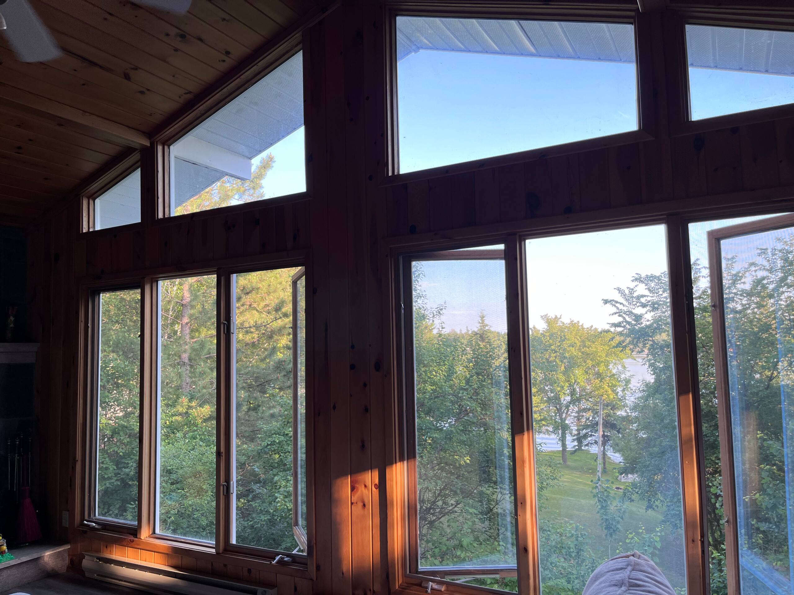 Floor to ceiling windows overlooking the trees and lake